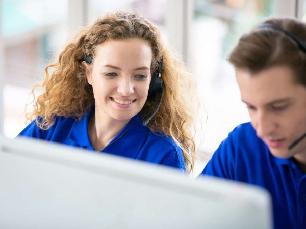 Young friendly operator woman agent with headset