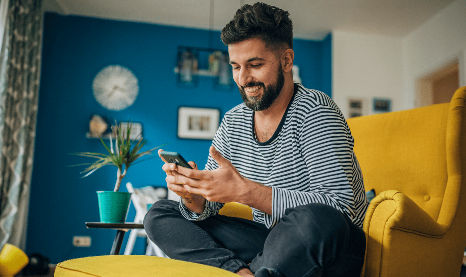 Man sat on chair looking at phone